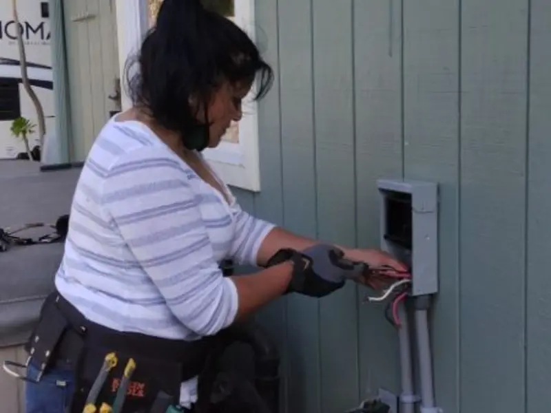 Licensed electrician wiring an exterior subpanel in Slaughterville
